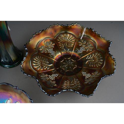 828 - Four pieces of early 20th century American Carnival glass from the Fenton factory, comprising a blue... 