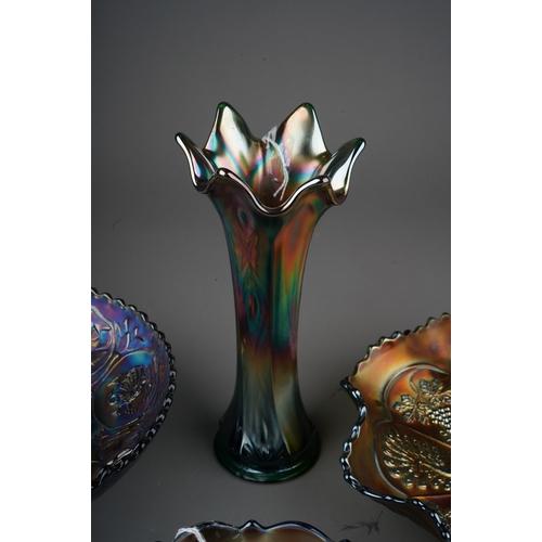 828 - Four pieces of early 20th century American Carnival glass from the Fenton factory, comprising a blue... 