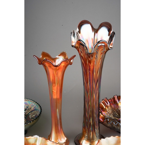 832 - Six pieces of early 20th century American Carnival glass from the Fenton factory, including a vaseli... 