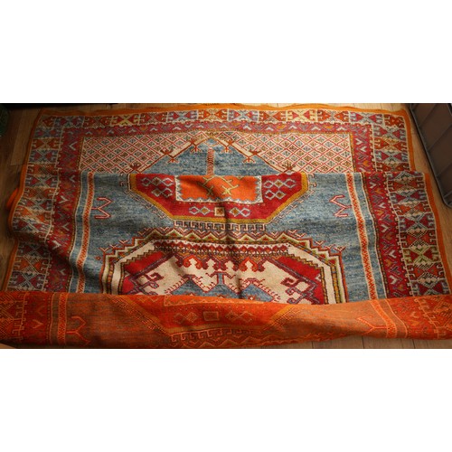 866 - A Moroccan large wool rug, central motif sections all on orange ground, 190 x 280cm