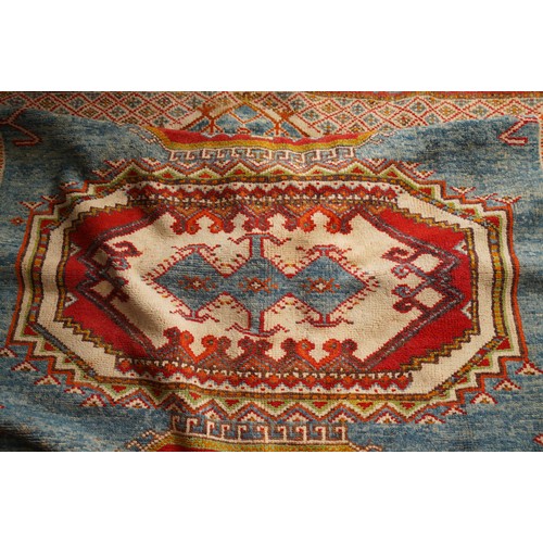 866 - A Moroccan large wool rug, central motif sections all on orange ground, 190 x 280cm