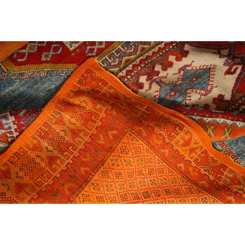 866 - A Moroccan large wool rug, central motif sections all on orange ground, 190 x 280cm