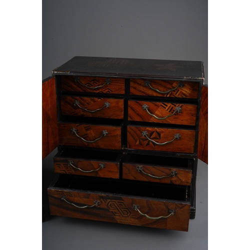 878 - An Asian vari wood marquetry jewellery cabinet, six drawer compartment over two short and long long ... 