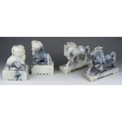 885 - Two pairs of 20th century carved soapstone figures, comprising a pair of horses and a pair of seated... 