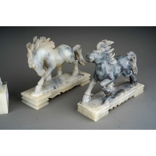 885 - Two pairs of 20th century carved soapstone figures, comprising a pair of horses and a pair of seated... 