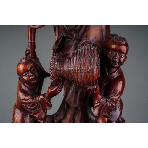 891 - Chinese Hardwood Carving of an elderly with 2 children by his feet helping him, 19th century.  With ... 