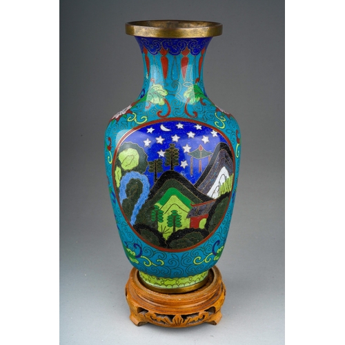 893 - A Japanese Cloisonne baluster vase decorated with stylised mountain scape, on carved wooden base