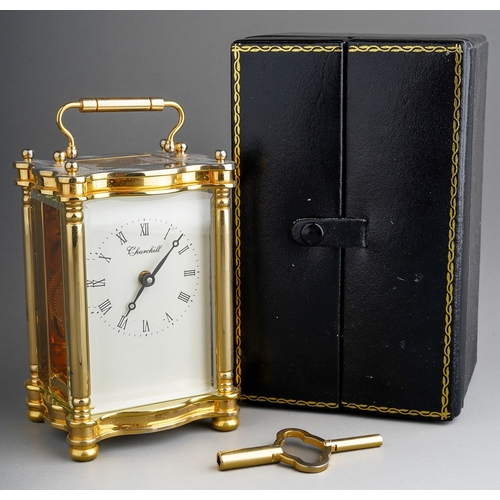 962 - A Churchill brass carriage clock, white dial with Roman numerals, approx 11cm high, boxed with key