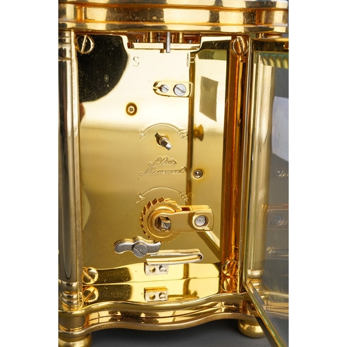 962 - A Churchill brass carriage clock, white dial with Roman numerals, approx 11cm high, boxed with key