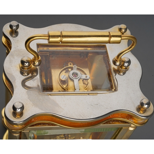 962 - A Churchill brass carriage clock, white dial with Roman numerals, approx 11cm high, boxed with key