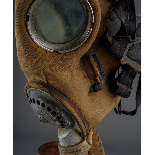 148 - WW2 British Army Respirator. Cloth covered facepeice type dated 1944. Plus a pair of post war Puttee... 