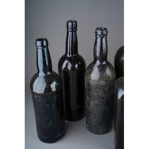 174 - A collection of nine 18th and 19th century green and brown glass bottles, six of tapered square form... 