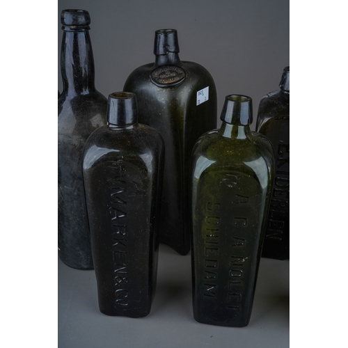 174 - A collection of nine 18th and 19th century green and brown glass bottles, six of tapered square form... 