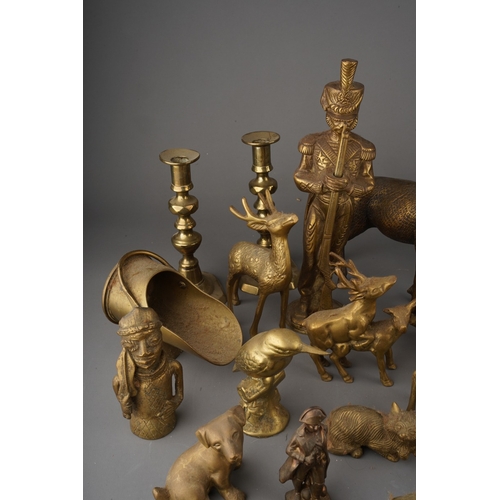 180 - A box of Victorian and 20th century brassware, including two pairs of candlesticks, models of deer, ... 