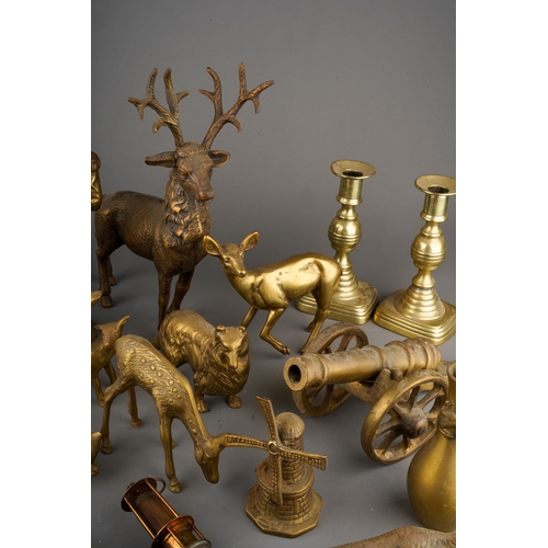 180 - A box of Victorian and 20th century brassware, including two pairs of candlesticks, models of deer, ... 