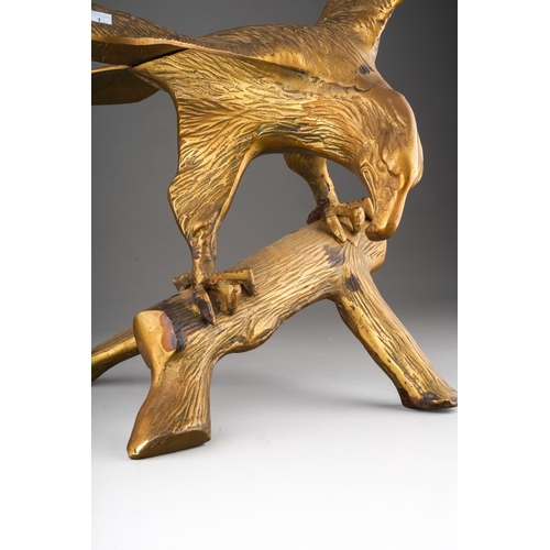 182 - A brass figure of an eagle with outstretched wing, modelled as perched on a branch, width 50cm x hei... 