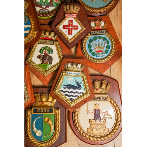 183 - A collection of twelve Royal Navy ships crest relief moulded painted plaster plaques mounted on wood... 