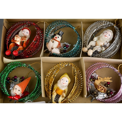 231 - A boxed set of six vintage Christmas decorations, metallic baubles each one containing a different c... 