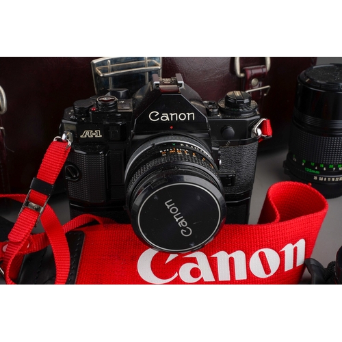 245 - A Canon A-1 manual camera and assorted to accessories including: Speedlite 177A; two fixed lenses an... 