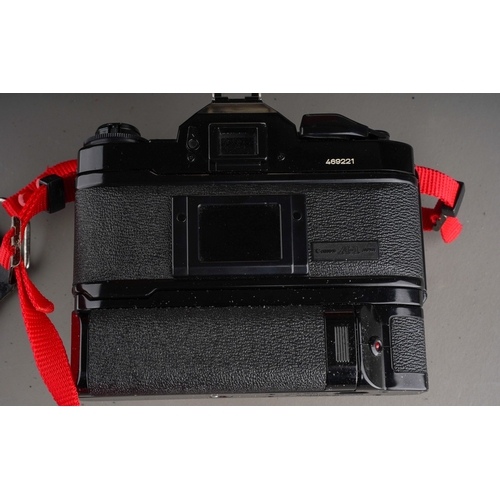 245 - A Canon A-1 manual camera and assorted to accessories including: Speedlite 177A; two fixed lenses an... 