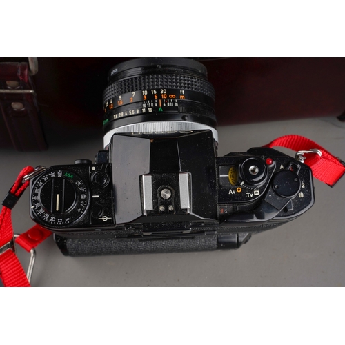 245 - A Canon A-1 manual camera and assorted to accessories including: Speedlite 177A; two fixed lenses an... 