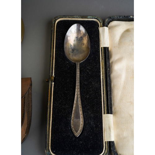 246 - A group of silver to include: napkin ring, cased spoon, two medals and a circular tortoiseshell clot... 