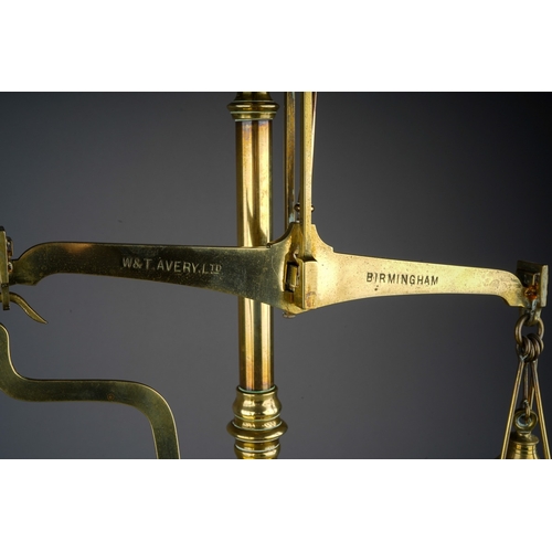 253 - An Edwardian Avery brass scales mounted with weights