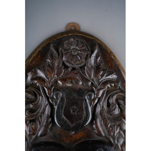 257 - A Scottish Victorian carved oak oval Armorial plaque mounted with rams horns