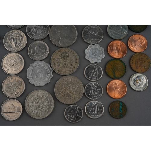 306 - A small collection of British and Foreign coins including two Churchill commemorative crowns, a 1972... 