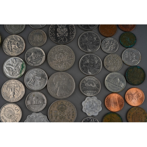 306 - A small collection of British and Foreign coins including two Churchill commemorative crowns, a 1972... 