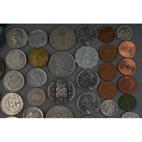 306 - A small collection of British and Foreign coins including two Churchill commemorative crowns, a 1972... 