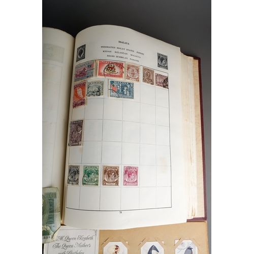 311 - A collection of British and World coins, two British banknotes, stamps and trade cards in albums and... 