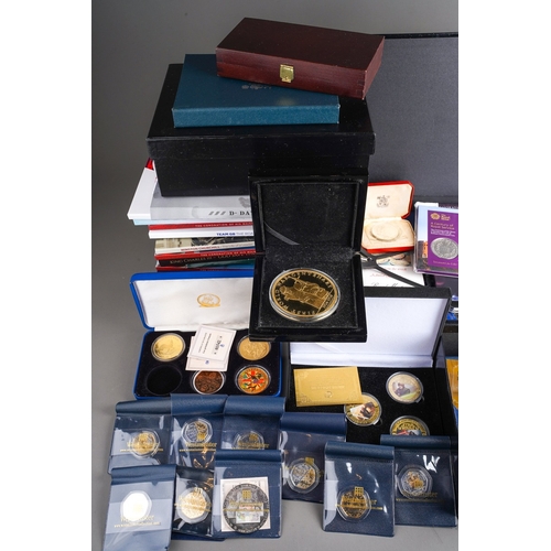 323 - A box of modern commemorative coins, empty coin boxes and packs