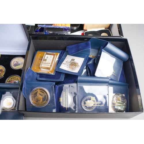 323 - A box of modern commemorative coins, empty coin boxes and packs