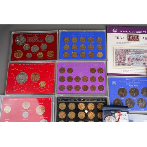 327 - A box of eleven GB coin sets, bank notes, Royal commemorative medallions, two 1 troy oz ingots of .9... 