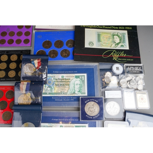 327 - A box of eleven GB coin sets, bank notes, Royal commemorative medallions, two 1 troy oz ingots of .9... 