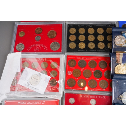 327 - A box of eleven GB coin sets, bank notes, Royal commemorative medallions, two 1 troy oz ingots of .9... 