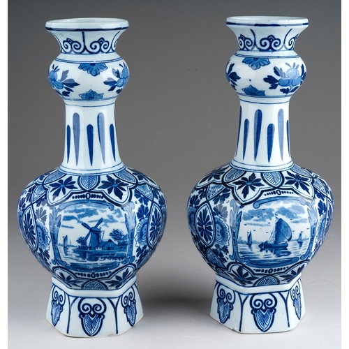 358 - A pair of 20th century Delft vases, printed in traditional blue with scenes of boats, on a deep hexa... 