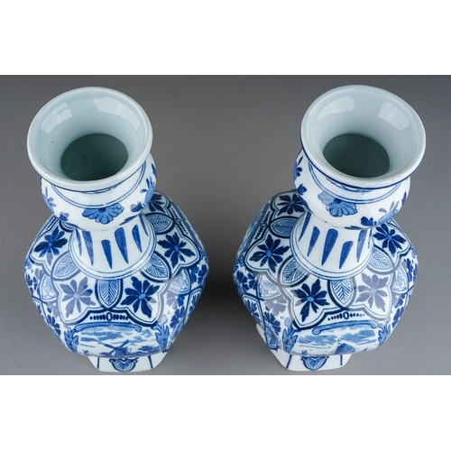 358 - A pair of 20th century Delft vases, printed in traditional blue with scenes of boats, on a deep hexa... 