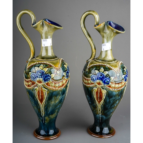 379 - A pair of Royal Doulton stoneware ewers, each on a mottled blue/green ground with glazed floral and ... 