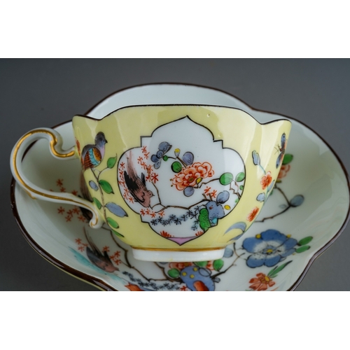 382 - An early 20th Century Meissen Chinoiserie quatrefoil shaped cup and saucer, yellow ground decorated ... 