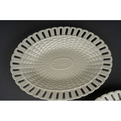 388 - A pair of Georgian style creamware oval basketweave plates with pierced borders, stamped to undersid... 