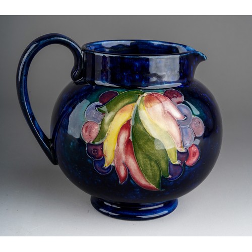 392 - Seven pieces of Moorcroft to include a Leaf and berry jug together with three various vases (anemone... 