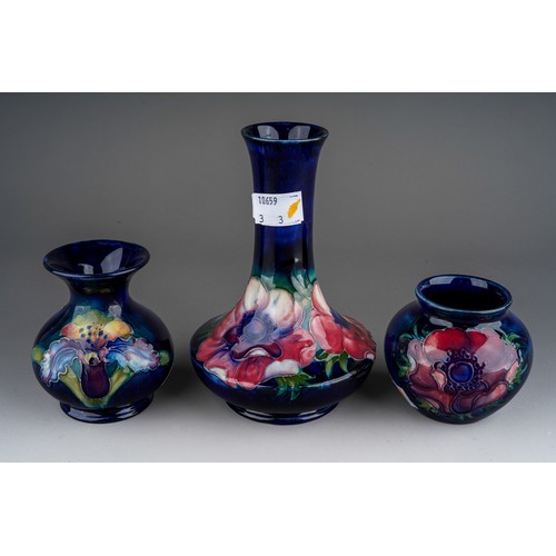 392 - Seven pieces of Moorcroft to include a Leaf and berry jug together with three various vases (anemone... 