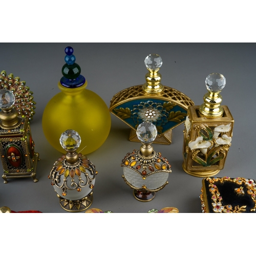 437 - A collection of  enameled filigree glass scent bottles, ornaments and enameled trinket pots. 
To inc... 