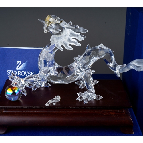 448 - Collection of boxed Swarovski crystal pieces to include a Topaz leaves tea light, dragon on stand, s... 