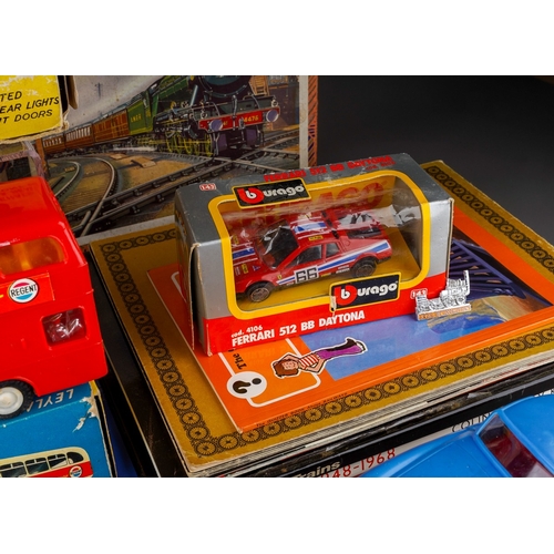 459 - A collection of boxed and loose toy cars, etc and railway related books, postcards, etc, including a... 