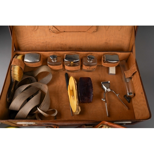 479 - An Art Deco style chrome mounted travelling set in leather case including two brushes with talc, soa... 