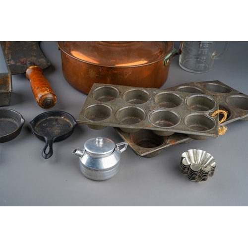 482 - Assorted vintage cooking utensils including mincer, fairy cake tins, copper pan and cover, cookery p... 