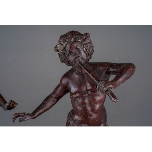 496 - A pair of early 20th Century bronze figures of Classical figures playing pipes (Pan) on raised integ... 